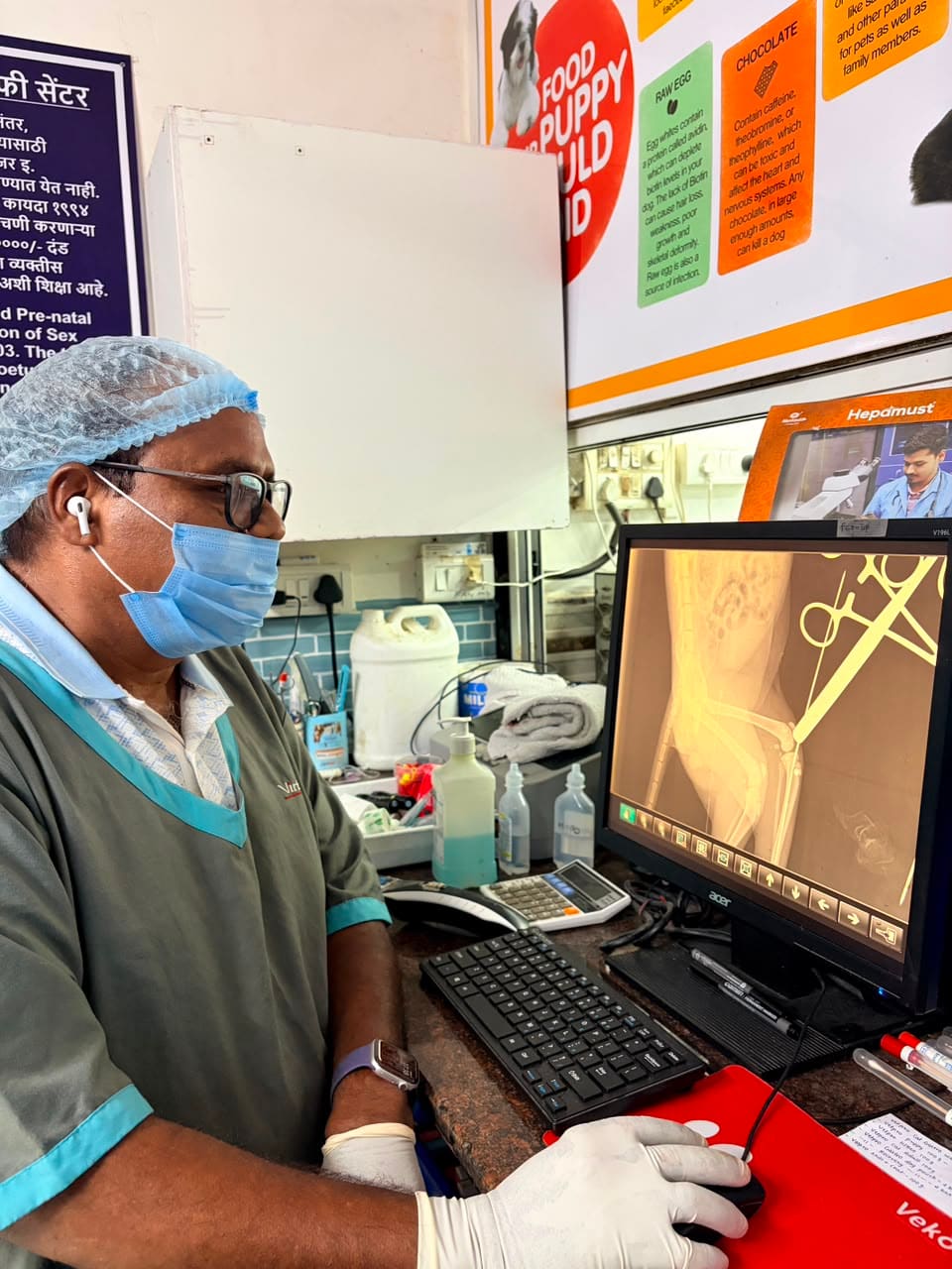 Dr. Shivaji Vidhate reviewing a cat X-ray on the monitor